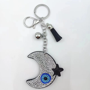 Moon and star rhinestone keychain with blue evil eye charm and black tassel fringe