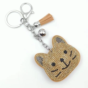 Sparkly champagne rhinestone cat keychain with leather fringe and silver metal clasp