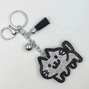 Detail of a sparkling rhinestone Scottish Terrier keychain with black tassel and silver bell