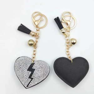 Sparkling rhinestone heart keychain with black lightning bolt and elegant gold tassel