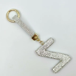 Detailed view of capital letter Z keychain with white rhinestones and golden spring clasp