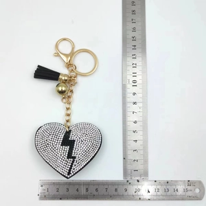 Detail view of heart rhinestone keychain with lightning bolt pattern and velvet back