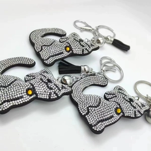 Three-piece set of cartoon cat keychains with white rhinestones and black leather tassels