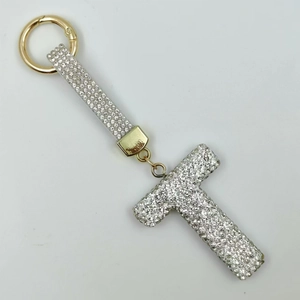 Detailed view of capital letter T keychain with sparkling rhinestones and gold hardware