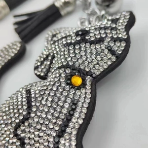 Sparkling rhinestone cartoon cat keychain with black tassels and silver metal link
