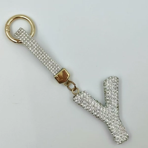 Detail view of rhinestone-studded letter Y keychain with golden spring clip buckle