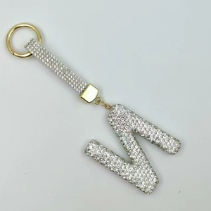 Detailed view of luxury letter N keychain with sparkling rhinestones and gold ring