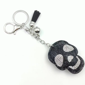 Punk style skull keychain with black rhinestones, silver lobster clasp and leather tassel