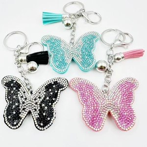 Détails des porte-clés papillon avec strass étincelants et pompons assortis