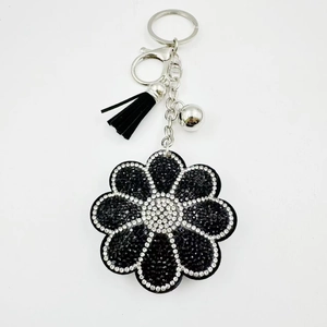 Porte-clés tournesol brillant avec strass noirs et pompon en cuir élégant pour sac