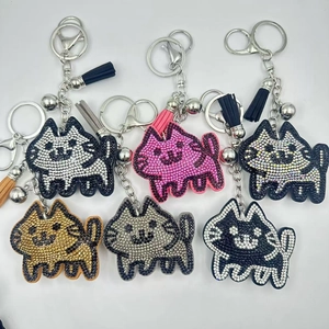 Detail of six sparkling rhinestone cat keychains with matching colorful leather tassels
