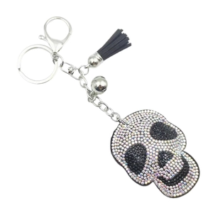 Skull keychain with colorful rhinestones, black leather tassel and silver bell detail