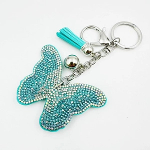 Porte-clés papillon élégant avec strass bleu tiffany et pompon en cuir souple