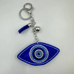 Sparkling rhinestone evil eye keychain with blue tassel and silver bell pendant