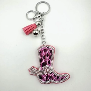 Detailed view of pink cowboy boot keychain with sparkling leopard print rhinestones and tassel