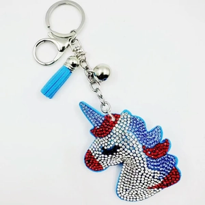 Sparkling crystal unicorn keychain with blue leather tassel and silver keyring bell