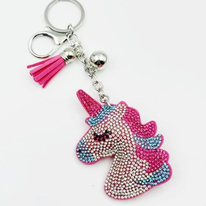 Close-up of pink unicorn keychain with glittering rhinestones and fiber tassel