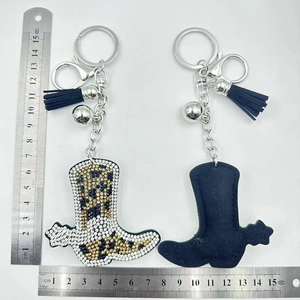 Detailed size view of leopard print and blue rhinestone cowboy boot keychain with tassels