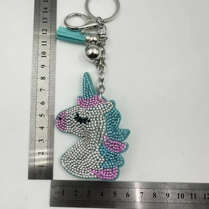 Detailed view of pink unicorn rhinestone keychain showing 7cm height with metal ruler