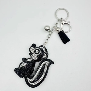 Sparkling skunk rhinestone keychain with black tassel and silver bell for bag or car decor