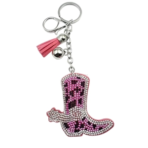 Pink rhinestone cowboy boot keychain with decorative tassel and silver bell accessory