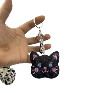Sparkling black rhinestone cat head keychain with blue eyes and silver hardware