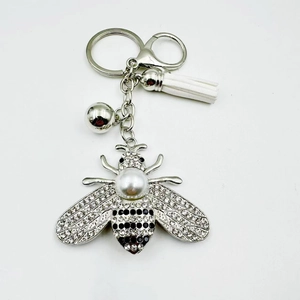 Sparkling bee keychain with crystal wings, large pearl back and white leather tassel