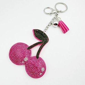 Sparkling pink rhinestone cherry keychain with green leaves and a matching leather tassel