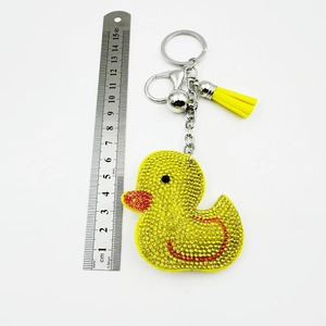 Detail view of rhinestone duck keychain with yellow tassel and measuring scale ruler