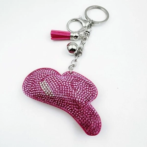 Detail of pink rhinestone cowboy hat keychain with metallic ring and leather tassel