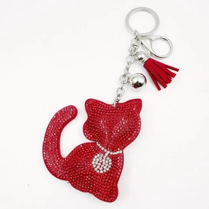 Detail of red rhinestone cat keychain with silver bell and matching tassel charm