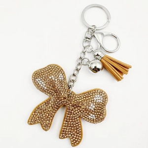 Detail of crystal bowknot keychain with gradient brown rhinestones and tassel
