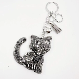 Sparkly grey rhinestone cat keychain with leather tassel and silver bell accessory