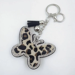 Leopard print butterfly keychain with silver metal chain, black tassel and crystal accents