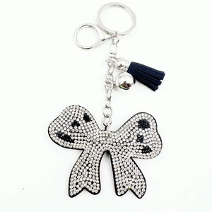 Luxury rhinestone bow keychain with black leather tassel and silver metal ring accents
