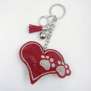 Sparkling red rhinestone heart keychain with white paw print, tassel and silver bell