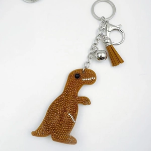Orange crystal rhinestone dinosaur keychain with matching leather tassel and silver hardware
