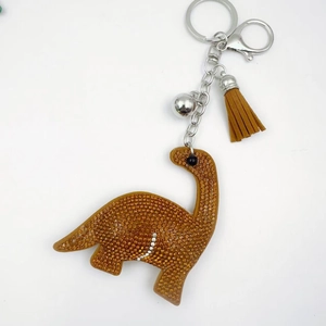 Brown crystal rhinestone dinosaur keychain with leather tassel and silver bell accessory