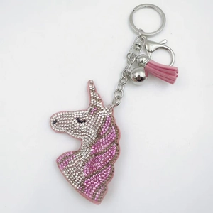 Sparkling crystal unicorn keychain with pink tassel and rhinestones on a silver base