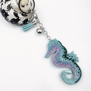 Sparkling seahorse keychain with blue leather tassel and crystal rhinestone detailing