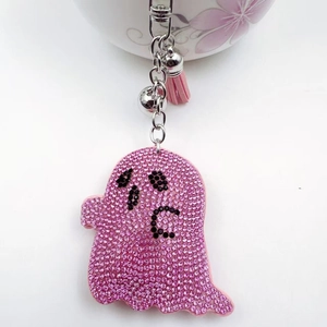 Porte-clés fantôme rose brillant avec strass clochette argentée et gland en cuir
