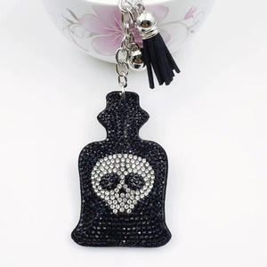 Gothic black rhinestone perfume bottle keychain with skull motif and tassel