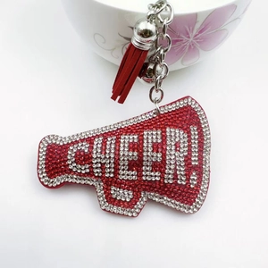 Detail of red rhinestone megaphone keychain with Cheer text and leather tassel
