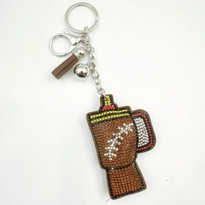 Sparkling brown football cup keychain with crystal rhinestones and leather tassel charm