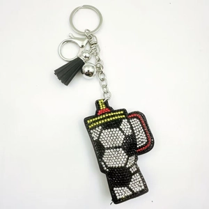 Detail of soccer pattern rhinestone cup keychain with black tassel and lobster clasp