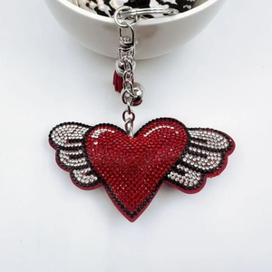 Fashion heart and wing keychain with red rhinestones and a stylish red tassel