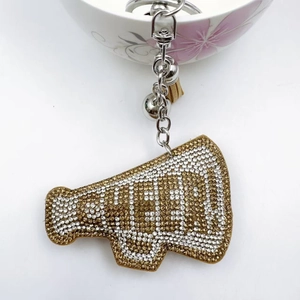 Detailed view of rhinestone megaphone keychain with tassel, bell, and CHEER lettering