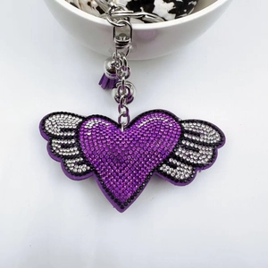 Sparkling purple heart keychain with rhinestone wings and a decorative matching tassel