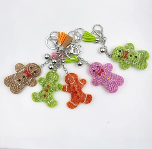 Detailed view of sparkling rhinestone gingerbread man keychains with colorful tassels