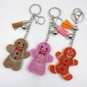 Handcrafted sparkling gingerbread man keychains with colorful rhinestones and leather tassels